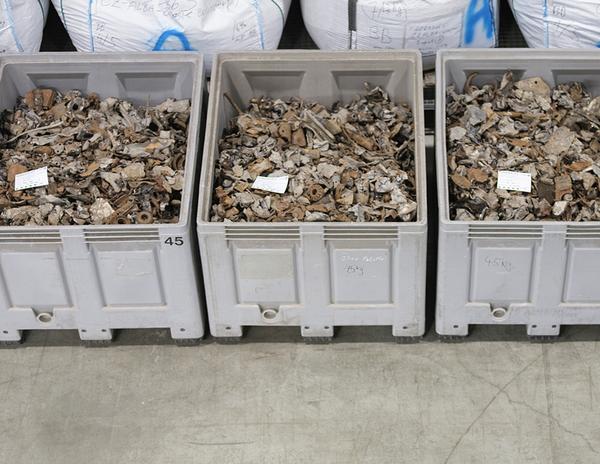Three open boxes filled with metal scrap in preparation for the recycling p.rocess