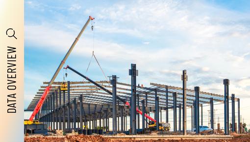 Construction site with crane and steel structure of an industrial building.