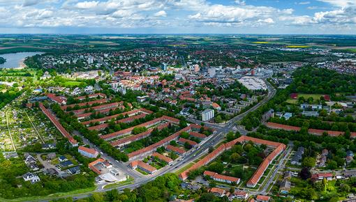 Aerial view of a city Aerial view of a city with residential areas, roads and industrial facilities under blue skies with white clouds.
